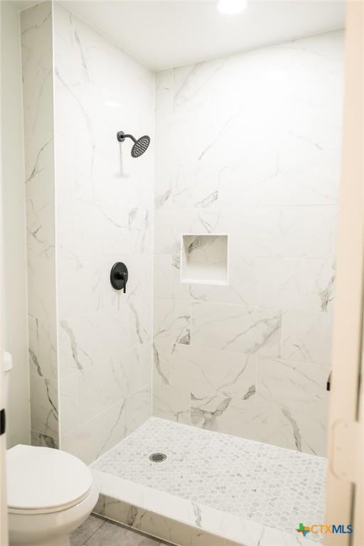 1004 Buena Vista Ave, Victoria, TX 77901 - bathroom featuring toilet and a marble finish shower