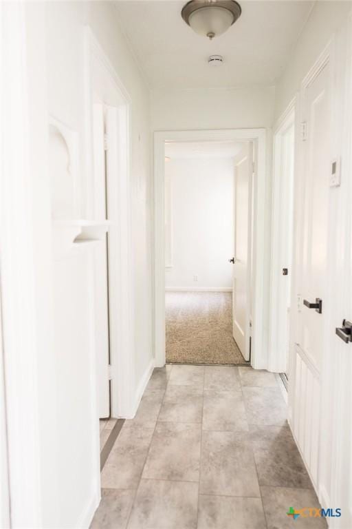 1004 Buena Vista Ave, Victoria, TX 77901 - hallway featuring light tile patterned flooring and light colored carpet