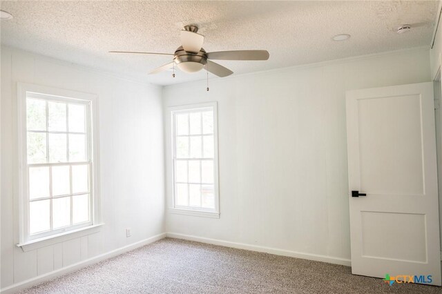 1004 Buena Vista Ave, Victoria, TX 77901 - unfurnished room featuring healthy amount of natural light, a textured ceiling, carpet flooring, a ceiling fan, and a smoke detector