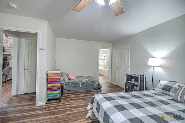 bedroom featuring dark wood-type flooring, ceiling fan, and ensuite bath