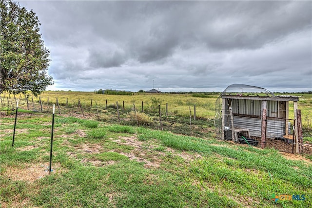 view of yard featuring an outdoor structure and a rural view