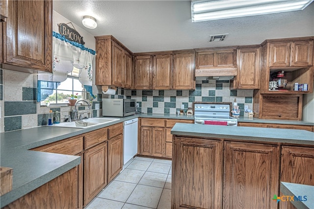 kitchen featuring sink, white appliances, decorative backsplash, and light tile patterned flooring