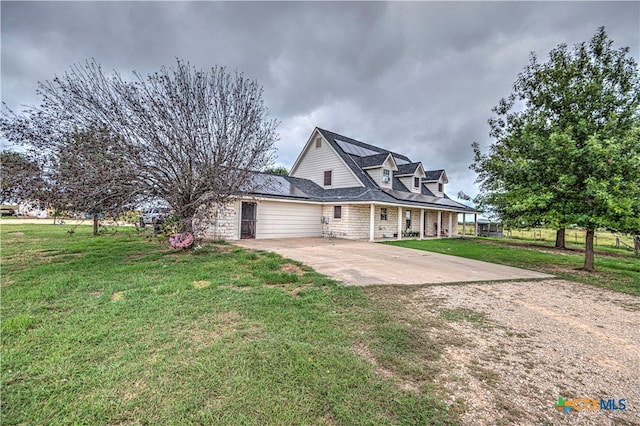 view of front of property featuring a front lawn and a patio area