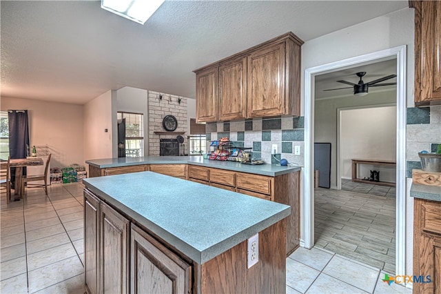 kitchen with tasteful backsplash, a textured ceiling, and ceiling fan