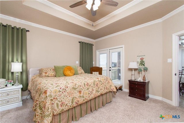 bedroom with light carpet, access to outside, crown molding, ceiling fan, and a tray ceiling