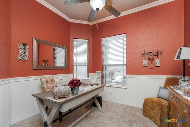 carpeted office space featuring ceiling fan and ornamental molding