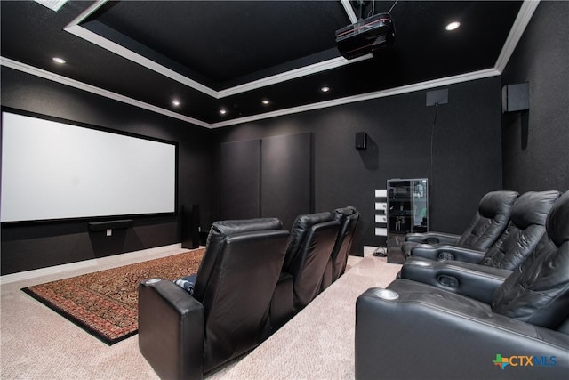 home theater featuring a tray ceiling, crown molding, and carpet