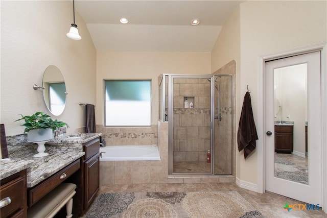 bathroom with tile patterned floors, vanity, independent shower and bath, and vaulted ceiling