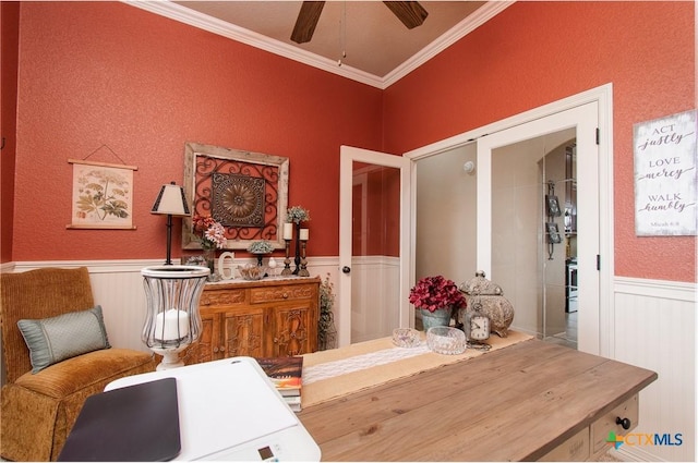 interior space with ceiling fan and ornamental molding