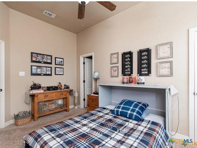 carpeted home office featuring ceiling fan