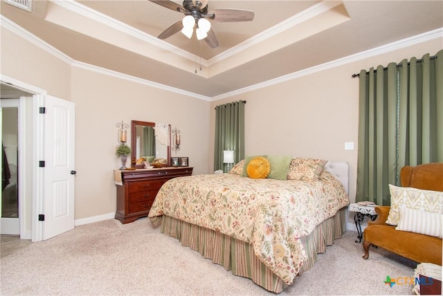 bedroom featuring carpet flooring, a tray ceiling, ceiling fan, and ornamental molding