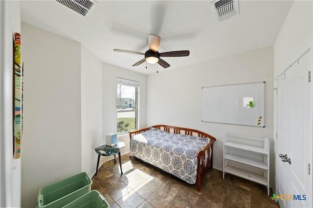bedroom featuring baseboards, visible vents, and a ceiling fan