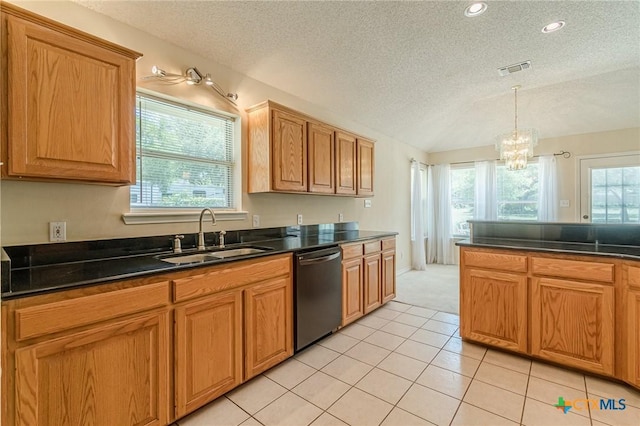 127 Maple Dr, Mountain City, TX 78610 - kitchen with stainless steel dishwasher, a textured ceiling, plenty of natural light, a chandelier, and dark countertops