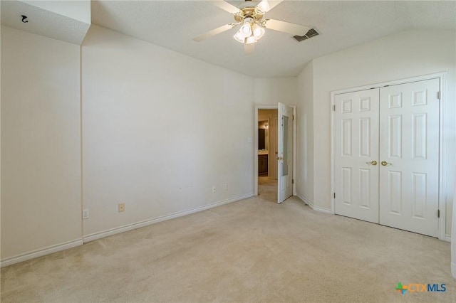127 Maple Dr, Mountain City, TX 78610 - unfurnished bedroom with light colored carpet, vaulted ceiling, ceiling fan, and a closet