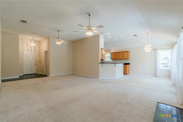 127 Maple Dr, Mountain City, TX 78610 - unfurnished living room featuring lofted ceiling, light colored carpet, a chandelier, ceiling fan, and a textured ceiling