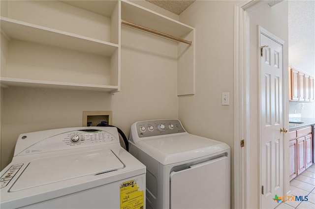 127 Maple Dr, Mountain City, TX 78610 - laundry room featuring washing machine and clothes dryer and light tile patterned flooring