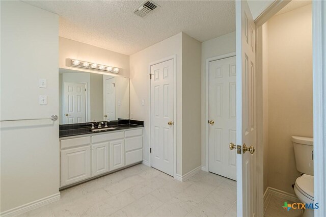 127 Maple Dr, Mountain City, TX 78610 - bathroom with vanity and a textured ceiling