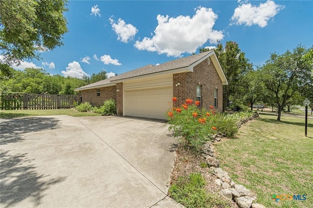 127 Maple Dr, Mountain City, TX 78610 - view of side of home with brick siding, concrete driveway, and a garage