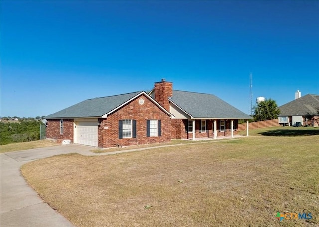 view of front of house featuring a garage, a porch, and a front lawn