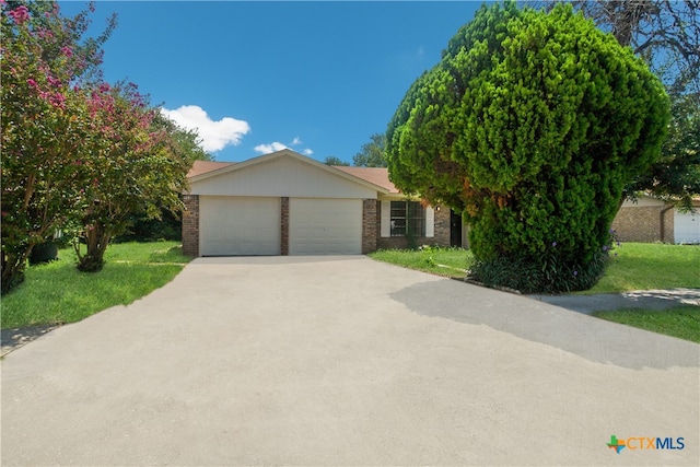 view of front of house featuring a garage and a front lawn