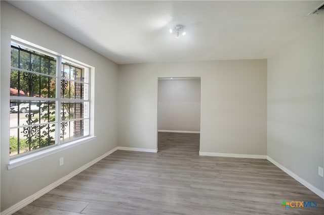 spare room with light wood-type flooring