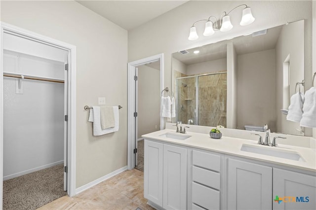 bathroom with a stall shower, a sink, a spacious closet, and toilet