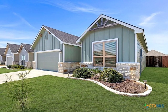 view of front facade featuring driveway, stone siding, a front lawn, and board and batten siding