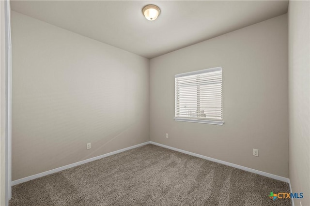 spare room with carpet floors and baseboards