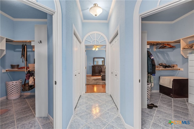 corridor with wood-type flooring and crown molding