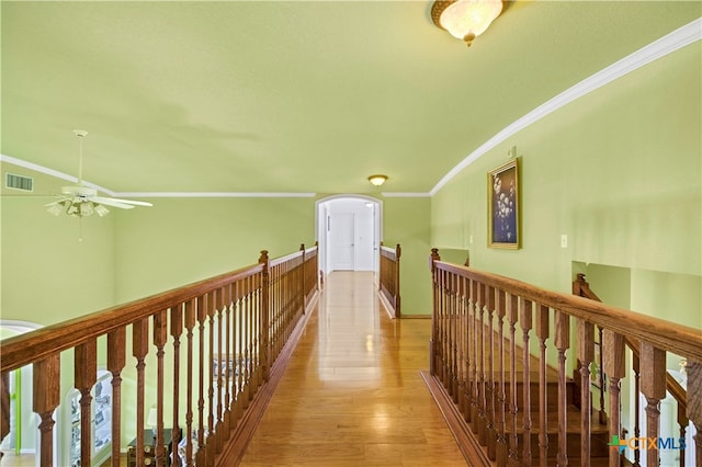 hall featuring ornamental molding and light hardwood / wood-style flooring