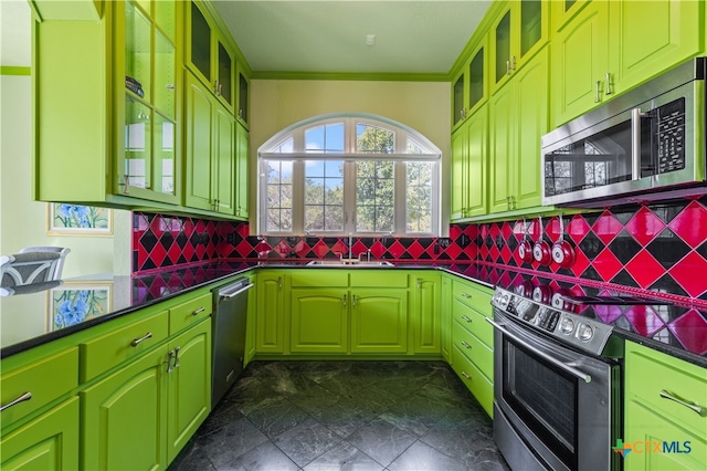 kitchen with sink, decorative backsplash, appliances with stainless steel finishes, and ornamental molding