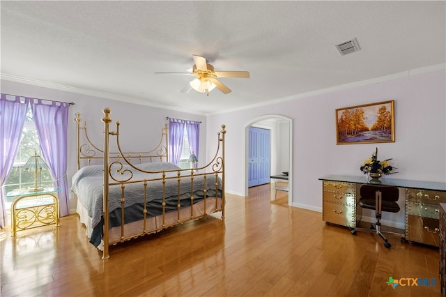 bedroom with wood-type flooring, multiple windows, and ceiling fan