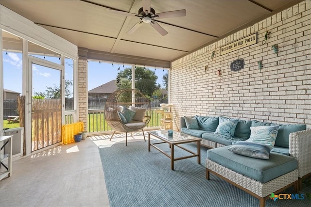 sunroom featuring ceiling fan