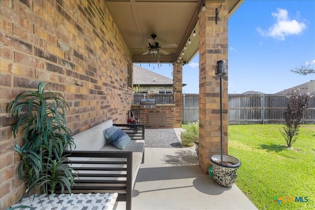 view of patio with ceiling fan, a grill, and exterior kitchen