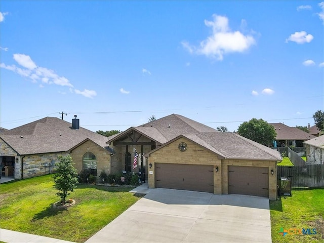 view of front of home with a garage and a front yard