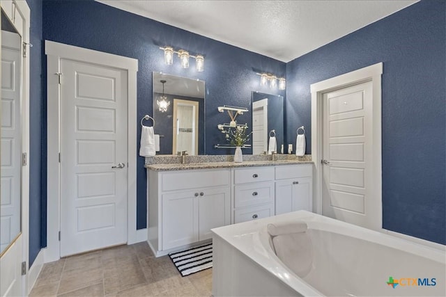 bathroom with vanity and a washtub