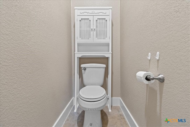 bathroom featuring tile patterned flooring and toilet