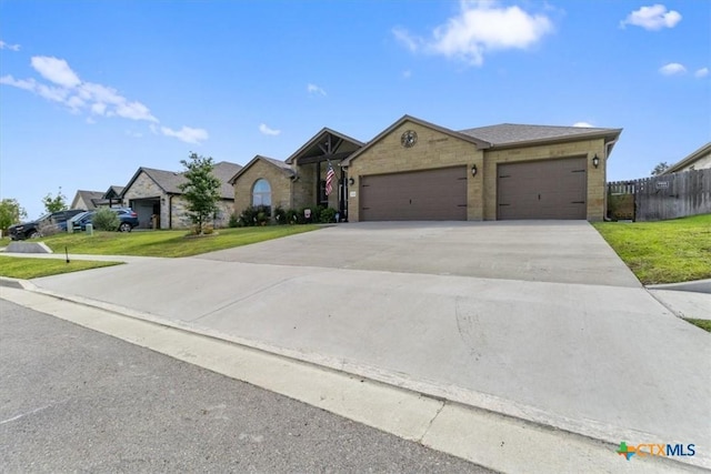 ranch-style home featuring a front lawn and a garage