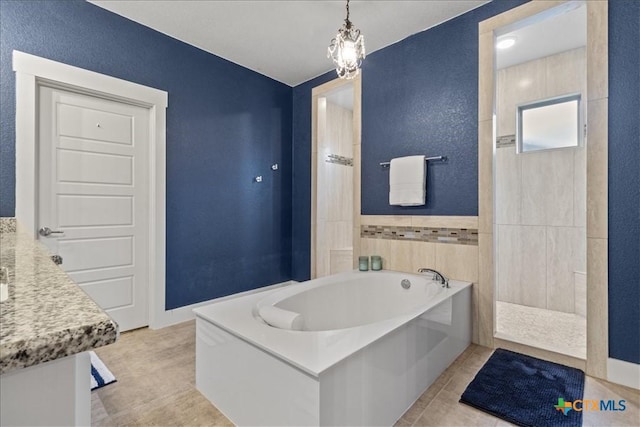 bathroom featuring shower with separate bathtub, tile patterned floors, and vanity