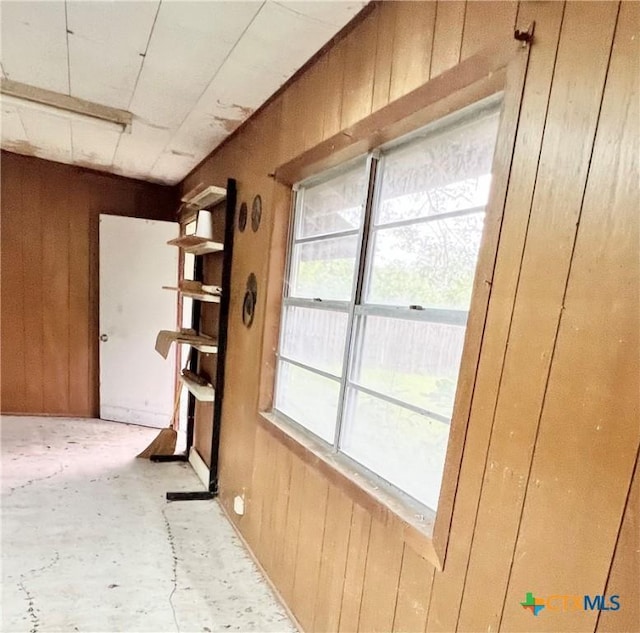 doorway with wood walls