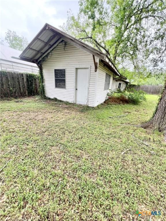 view of outbuilding with fence