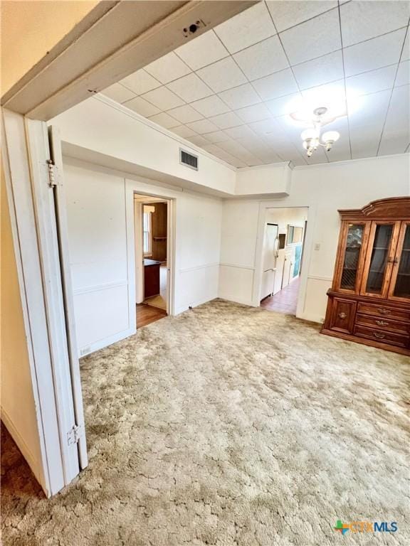 interior space with carpet and visible vents