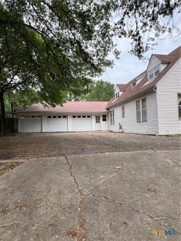 new england style home featuring aphalt driveway