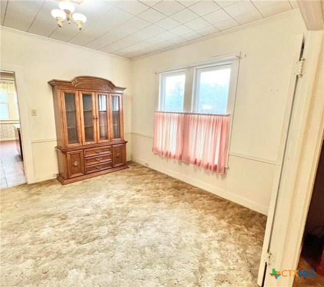 unfurnished room featuring ornamental molding, carpet flooring, and a healthy amount of sunlight