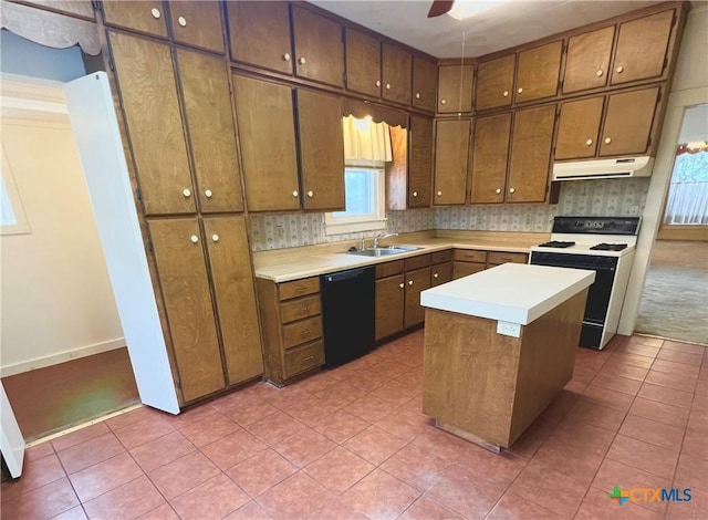 kitchen with a sink, under cabinet range hood, light tile patterned flooring, electric range oven, and dishwasher