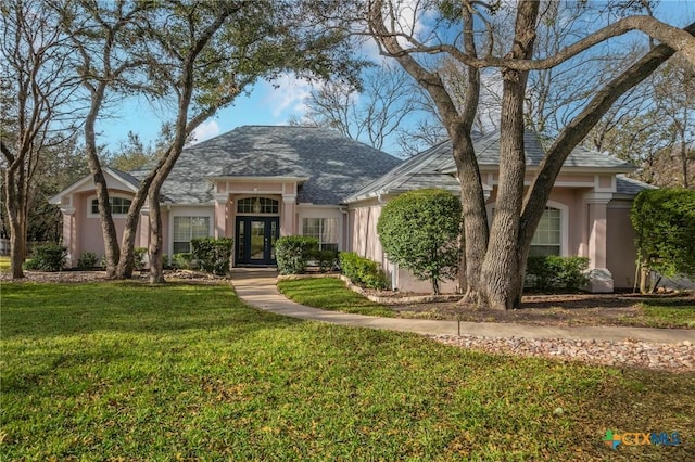 view of front of house with french doors and a front yard