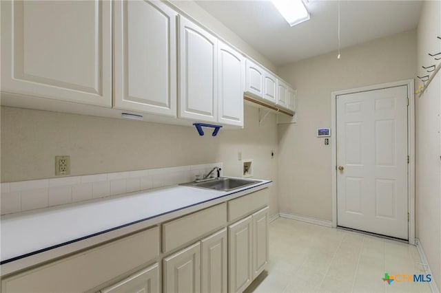 clothes washing area featuring sink, cabinets, hookup for an electric dryer, and washer hookup