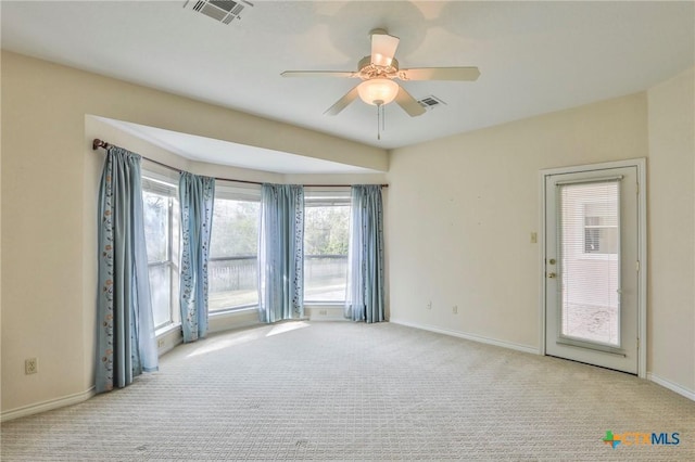 carpeted spare room with ceiling fan