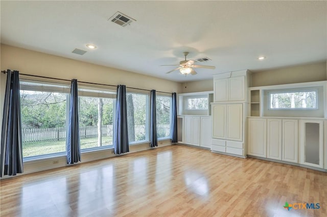 interior space with ceiling fan and light hardwood / wood-style flooring