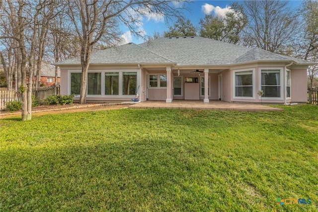 rear view of property with a patio and a lawn